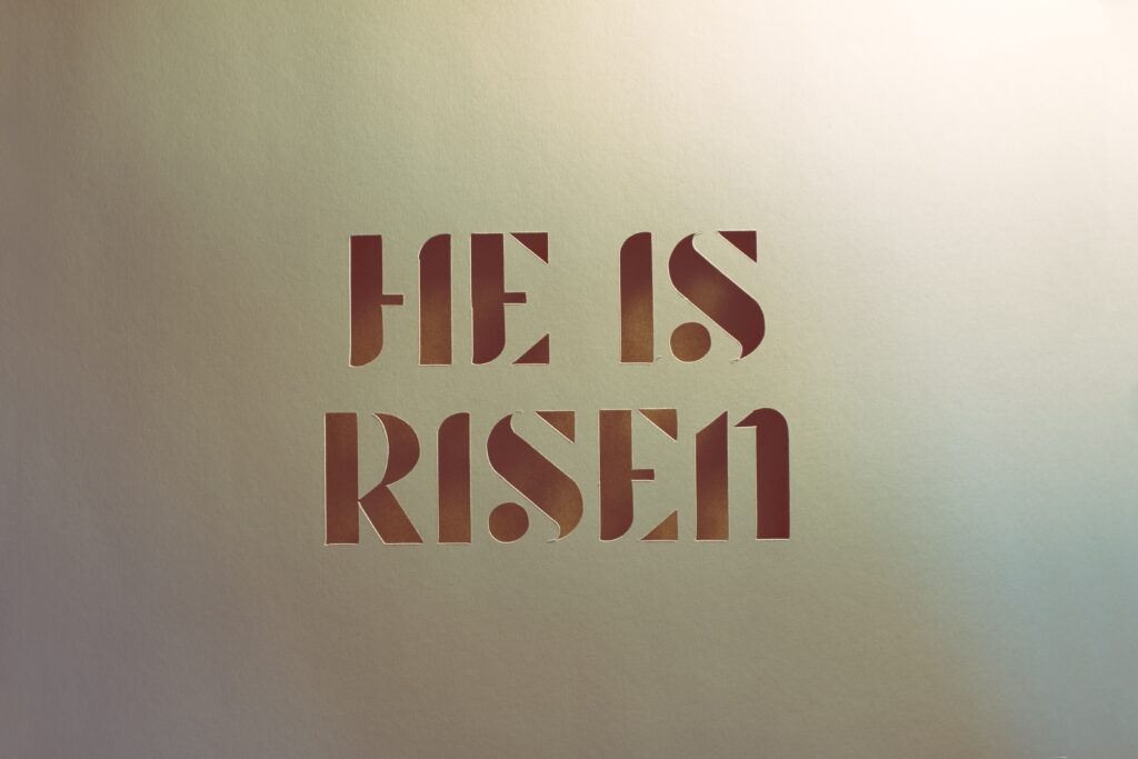 white background with font that reads He is Risen